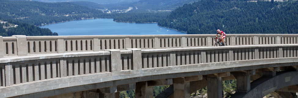 Cyclist on Highway 40 bridge overlooking Donner Lake, California