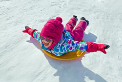 girl on saucer in the snow